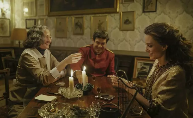 This image released by Netflix shows, from left, Alba Rohrwacher, as Bruna Lupoli, Pierfrancesco Favino, as Ferruccio Mezzadri, and Angelina Jolie, as Maria Callas, in a scene from "Maria." (Pablo Larraín/Netflix via AP)