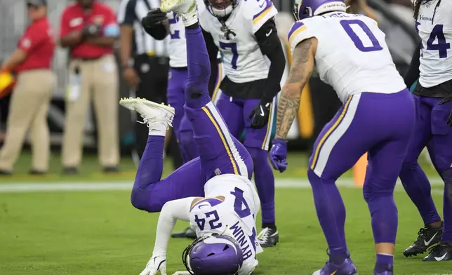 Minnesota Vikings safety Camryn Bynum (24) celebrates after intercepting a pass during the second half of an NFL football game against the Jacksonville Jaguars, Sunday, Nov. 10, 2024, in Jacksonville, Fla. (AP Photo/John Raoux)