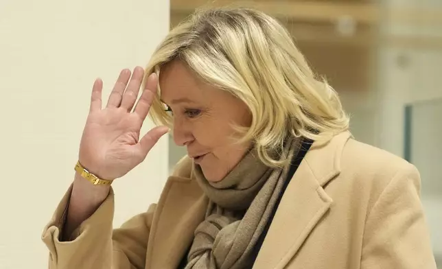 French far-right leader Marine Le Pen arrives at the courtroom for the last day of the trial on charges of embezzling European Parliament funds, Wednesday, Nov. 27, 2024 in Paris. (AP Photo/Aurelien Morissard)