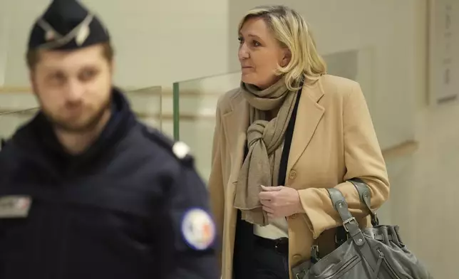 French far-right leader Marine Le Pen arrives at the courtroom for the last day of the trial on charges of embezzling European Parliament funds, Wednesday, Nov. 27, 2024 in Paris. (AP Photo/Aurelien Morissard)