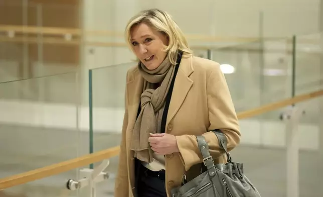 French far-right leader Marine Le Pen arrives at the courtroom for the last day of the trial on charges of embezzling European Parliament funds, Wednesday, Nov. 27, 2024 in Paris. (AP Photo/Aurelien Morissard)