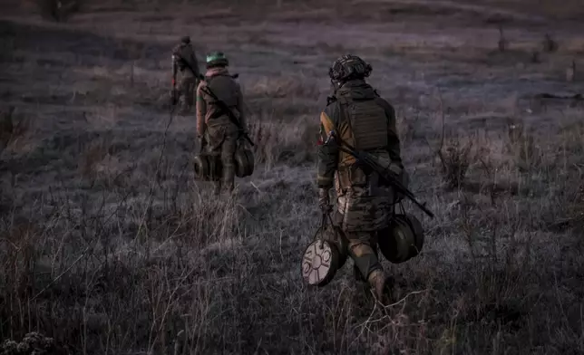 FILE - In this photo provided by Ukraine's 24th Mechanised Brigade press service, servicemen of the 24th Mechanised Brigade install anti-tank landmines and non explosive obstacles along the front line near Chasiv Yar town in Donetsk region, Ukraine, on Oct. 30, 2024. (Oleg Petrasiuk/Ukrainian 24th Mechanised Brigade via AP, File)