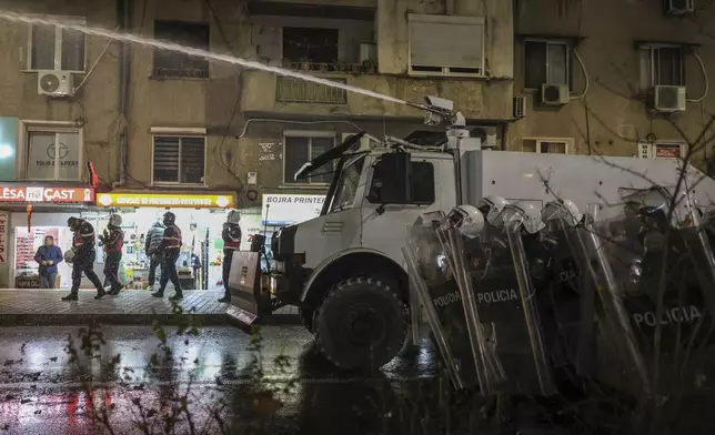 Police use water canons against opposition supporters in Tirana, Albania , Tuesday, Nov. 26, 2024 during an anti-government protest over the arrests of their leader Sali Berisha and former President Ilir Meta in separate corruption cases, saying the charges are politically motivated. (AP Photo/Vlasov Sulaj)