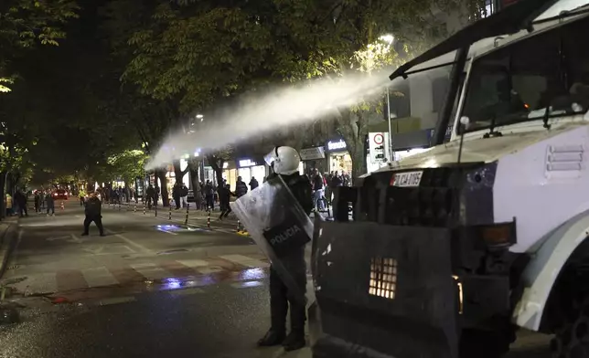 Police use water canons against opposition supporters in Tirana, Albania, Tuesday, Nov. 26, 2024 during an anti-government protest over the arrests of their leader Sali Berisha and former President Ilir Meta in separate corruption cases, saying the charges are politically motivated. (AP Photo/Vlasov Sulaj)