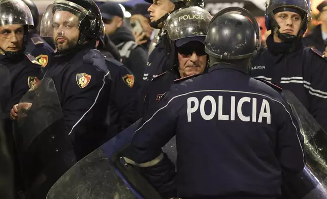 Riot police stand guard a street in central Tirana, Albania, Tuesday, Nov. 26, 2024 during an anti-government protest over the arrests of their leader Sali Berisha and former President Ilir Meta in separate corruption cases, saying the charges are politically motivated. (AP Photo/Vlasov Sulaj)