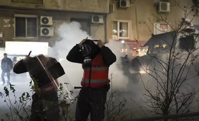 Riot police wear their gas masks during a protest, in Tirana, Albania, Tuesday, Nov. 26, 2024 over the arrests of their leader Sali Berisha and former President Ilir Meta in separate corruption cases, saying the charges are politically motivated. (AP Photo/Vlasov Sulaj)