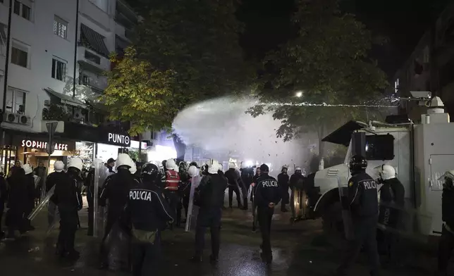 Police use water canons against opposition supporters in Tirana, Albania, Tuesday, Nov. 26, 2024 during an anti-government protest over the arrests of their leader Sali Berisha and former President Ilir Meta in separate corruption cases, saying the charges are politically motivated. (AP Photo/Vlasov Sulaj)