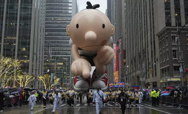 Handlers guide the Greg Heffley balloon down Sixth Avenue during the Macy's Thanksgiving Day Parade, Thursday, Nov. 28, 2024, in New York. (AP Photo/Julia Demaree Nikhinson)