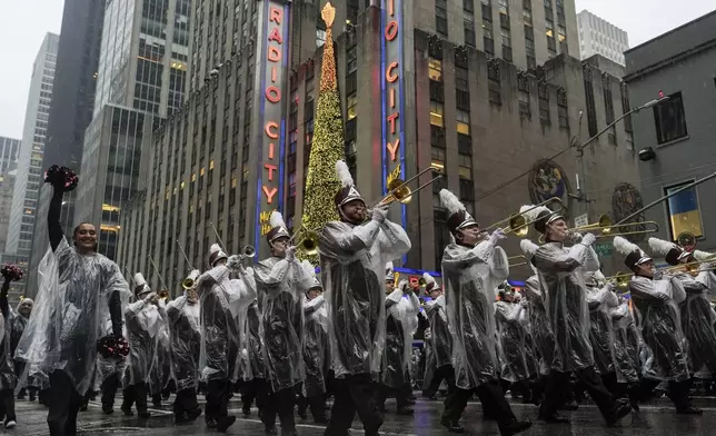 The University of Massachusetts Minutemen marching band plays as it makes its way down Central Park West while participating in the Macy's Thanksgiving Day Parade, Thursday, Nov. 28, 2024, in New York. (AP Photo/Julia Demaree Nikhinson)