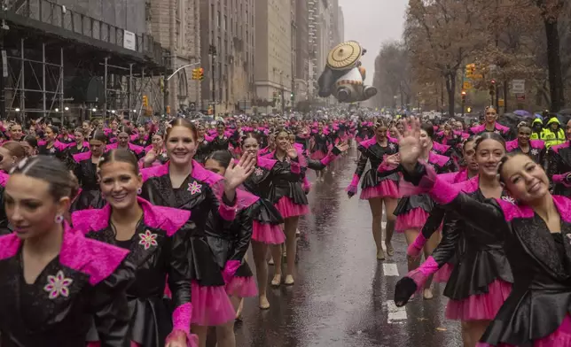 Parade performers march down Central Park West during the Macy's Thanksgiving Day parade, Thursday, Nov. 28 2024, in New York. (AP Photo/Yuki Iwamura)