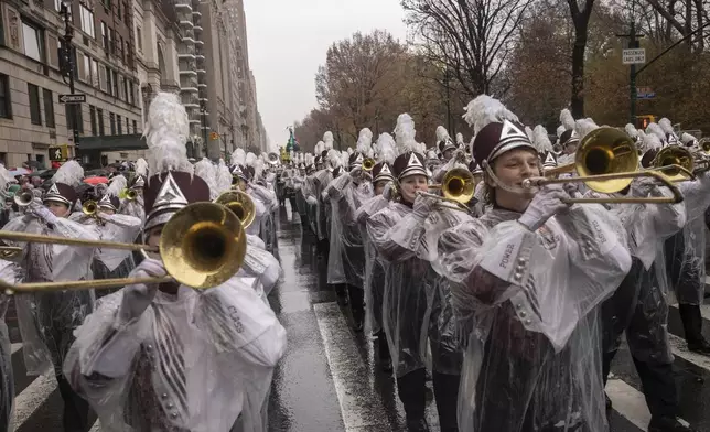 Members of University of Massachusetts Minutemen marching band march along Central Park West during the Macy's Thanksgiving Day parade, Thursday, Nov. 28 2024, in New York. (AP Photo/Yuki Iwamura)