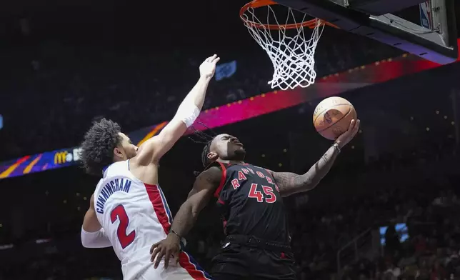 Toronto Raptors' Davion Mitchell shoots on Detroit Pistons Cade Cunningham during the first half of an Emirates NBA Cup basketball game, Friday, Nov. 15, 2024 in Toronto. (Chris Young/The Canadian Press via AP)