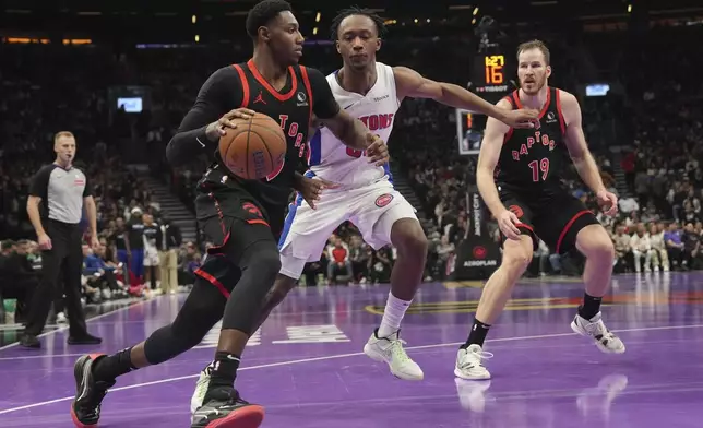 Toronto Raptors' RJ Barrett drives past Detroit Pistons' forward Ronald Holland II as Raptors Jakob Poeltl looks on during the first half of an Emirates NBA Cup basketball game, Friday, Nov. 15, 2024 in Toronto. (Chris Young/The Canadian Press via AP)