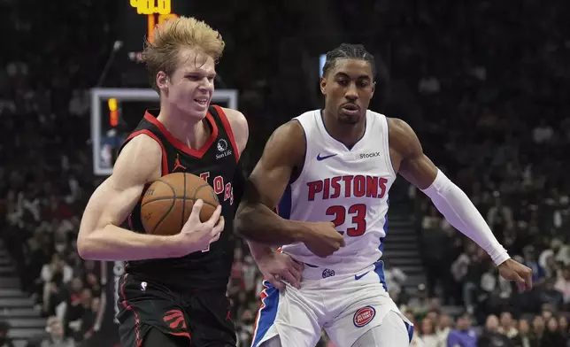 Toronto Raptors' Gradey Dick drives past Detroit Pistons' Jaden Ivey during the first half of an Emirates NBA Cup basketball game, Friday, Nov. 15, 2024 in Toronto. (Chris Young/The Canadian Press via AP)