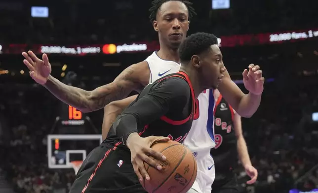 Toronto Raptors' RJ Barrett drives past Detroit Pistons' forward Ronald Holland II during the first half of an Emirates NBA Cup basketball game, Friday, Nov. 15, 2024 in Toronto. (Chris Young/The Canadian Press via AP)