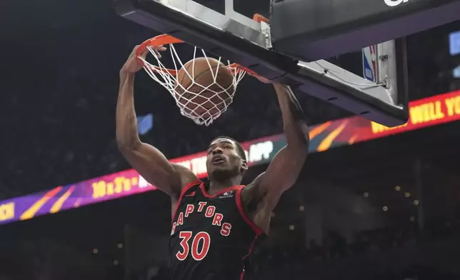 Toronto Raptors' Ochai Agbaji dunks against the Detroit Pistons during the first half of an Emirates NBA Cup basketball game, Friday, Nov. 15, 2024 in Toronto. (Chris Young/The Canadian Press via AP)