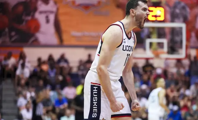 UConn forward Alex Karaban (11) reacts during the first half of an NCAA college basketball game against Memphis at the Maui Invitational Monday, Nov. 25, 2024, in Lahaina, Hawaii. (AP Photo/Lindsey Wasson)