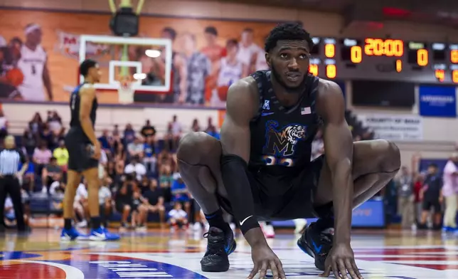 Memphis center Moussa Cisse stretches before an NCAA college basketball game against UConn at the Maui Invitational Monday, Nov. 25, 2024, in Lahaina, Hawaii. (AP Photo/Lindsey Wasson)