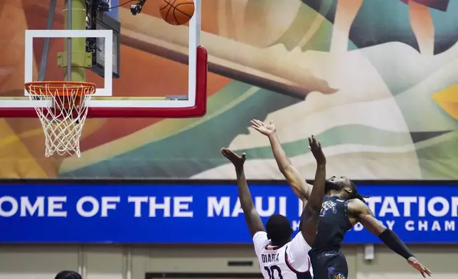 Memphis guard Tyrese Hunter goes up to the basket against UConn guard Hassan Diarra (10) during the first half of an NCAA college basketball game at the Maui Invitational Monday, Nov. 25, 2024, in Lahaina, Hawaii. (AP Photo/Lindsey Wasson)