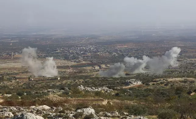 CORRECTS CITY Smoke rises amid fighting between opposition factions and Syrian government troops in Dadikh, Idlib countryside, Syria, Thursday, Nov. 28, 2024. (AP Photo/Ghaith Alsayed)