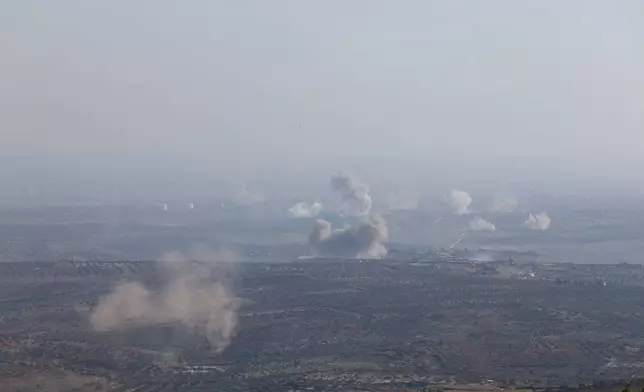 CORRECTS CITY. Smoke rises amid fighting between opposition factions and Syrian government troops in Dadikh, Idlib countryside, Syria, Thursday, Nov. 28, 2024. (AP Photo/Ghaith Alsayed)