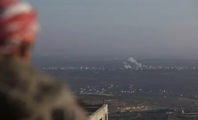 Smoke rises amid fighting between opposition factions and Syrian government troops in Majdaliya, Aleppo countryside, Syria, Thursday, Nov. 28, 2024. (AP Photo/Ghaith Alsayed)