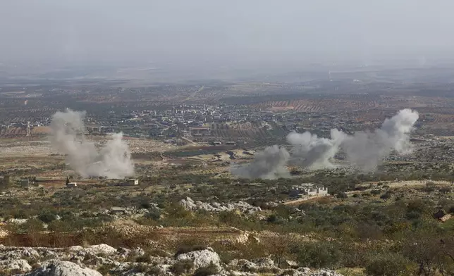 Smoke rises amid fighting between opposition factions and Syrian government troops in Dadikh, Aleppo countryside, Syria, Thursday, Nov. 28, 2024. (AP Photo/Ghaith Alsayed)