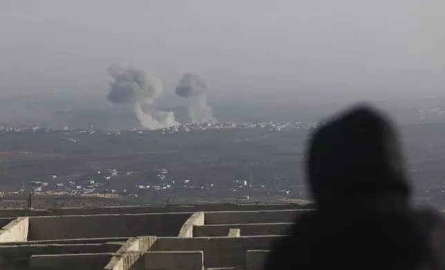 Smoke rises amid fighting between opposition factions and Syrian government troops in Majdaliya, Aleppo countryside, Syria, Thursday, Nov. 28, 2024. (AP Photo/Ghaith Alsayed)