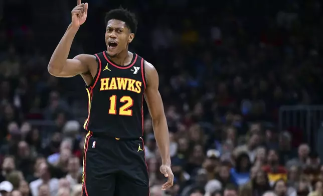 Atlanta Hawks forward De'Andre Hunter reacts after making a basket in the first half of an NBA basketball game against the Cleveland Cavaliers, Wednesday, Nov. 27, 2024, in Cleveland. (AP Photo/David Dermer)