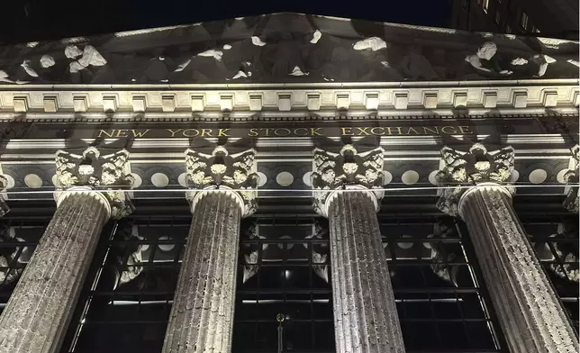 The facade of the New York Stock Exchange is illuminated on Tuesday, Nov. 19, 2024. (AP Photo/Peter Morgan)