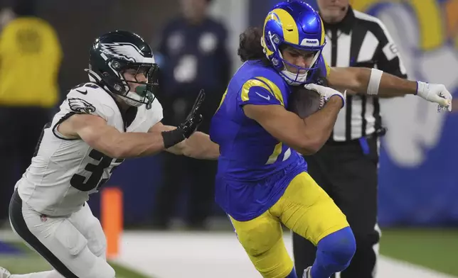 Los Angeles Rams wide receiver Puka Nacua, right, runs against Philadelphia Eagles cornerback Cooper DeJean during the second half of an NFL football game in Inglewood, Calif., Sunday, Nov. 24, 2024. (AP Photo/Mark J. Terrill)