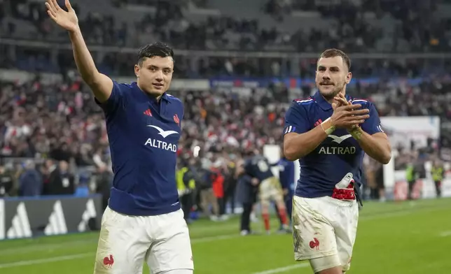 France's Louis Bielle-Biarrey, left, and teammate Gabin Villière gesture to fans following the Autumn Nations Series rugby international between France and Argentina at the Stade de France stadium at Saint-Denis on the outskirts of Paris, Friday, Nov. 22, 2024. (AP Photo/Thibault Camus)