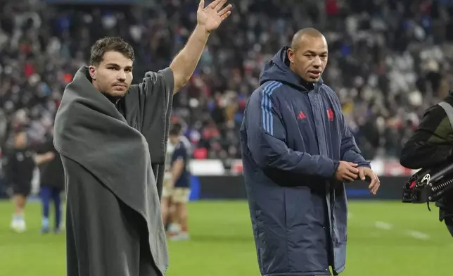 France's Antoine Dupont, left, and teammate Gaël Fickou react to supporters following the Autumn Nations Series rugby international between France and Argentina at the Stade de France stadium at Saint-Denis on the outskirts of Paris, Friday, Nov. 22, 2024. (AP Photo/Thibault Camus)