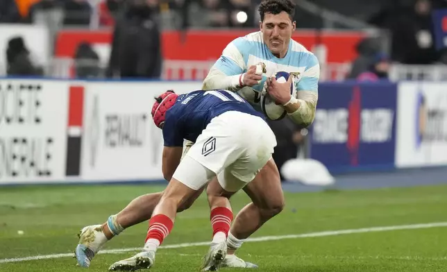 Argentina's Rodrigo Isgro is tackled by France's Louis Bielle-Biarrey during the Autumn Nations Series rugby international between France and Argentina at the Stade de France stadium at Saint-Denis on the outskirts of Paris, Friday, Nov. 22, 2024. (AP Photo/Thibault Camus)