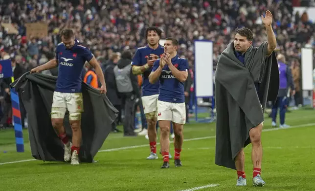 France's Antoine Dupont, right, waves to supporters following the Autumn Nations Series rugby international between France and Argentina at the Stade de France stadium at Saint-Denis on the outskirts of Paris, Friday, Nov. 22, 2024. (AP Photo/Thibault Camus)