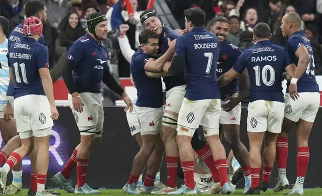 France's Thibaud Flament, centre, is congratulated by teammate Antoine Dupont after scoring a try during the Autumn Nations Series rugby international between France and Argentina at the Stade de France stadium at Saint-Denis on the outskirts of Paris, Friday, Nov. 22, 2024. (AP Photo/Thibault Camus)