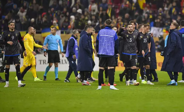 Kosovo players leave the pitch during the UEFA Nations League soccer match between Romania and Kosovo at the National Arena stadium in Bucharest, Romania, Saturday, Nov. 16, 2024. (AP Photo/Alexandru Dobre)