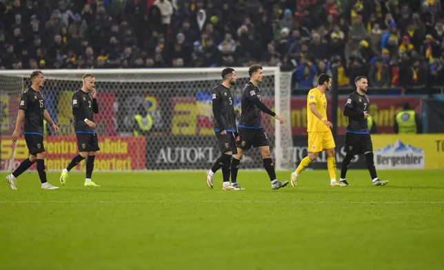 Kosovo players leave the pitch during the UEFA Nations League soccer match between Romania and Kosovo at the National Arena stadium in Bucharest, Romania, Saturday, Nov. 16, 2024. (AP Photo/Alexandru Dobre)