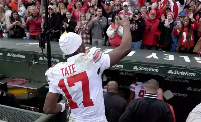 Ohio State wide receiver Carnell Tate waves to fans after the team's 31-7 win over Northwestern in an NCAA college football game at Wrigley Field on Saturday, Nov. 16, 2024, in Chicago. (AP Photo/Charles Rex Arbogast)