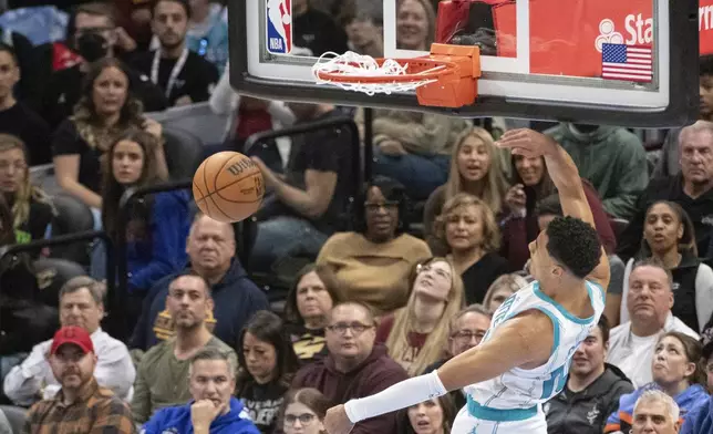 Charlotte Hornets' Cody Martin dunks against the Cleveland Cavaliers during the first half of an NBA basketball game in Cleveland, Sunday, Nov 17, 2024. (AP Photo/Phil Long)