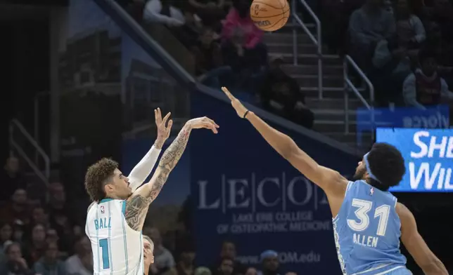 Charlotte Hornets' LaMelo Ball (1) shoots over Cleveland Cavaliers' Jarrett Allen (31) during the first half of an NBA basketball game in Cleveland, Sunday, Nov 17, 2024. (AP Photo/Phil Long)