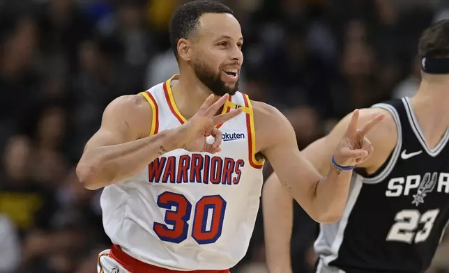 Golden State Warriors guard Stephen Curry (30) celebrates after a 3-point basket during the first half of an NBA basketball game against the San Antonio Spurs, Saturday, Nov. 23, 2024, in San Antonio. (AP Photo/Darren Abate)