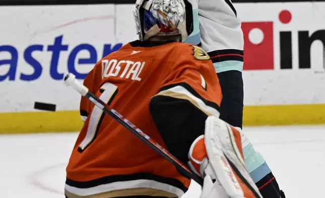 Seattle Kraken left wing Jared McCann, top, watches the puck get behind Anaheim Ducks goaltender Lukas Dostal (1) during the second period of an NHL hockey game in Anaheim, Calif., Monday, Nov. 25, 2024. (AP Photo/Alex Gallardo)