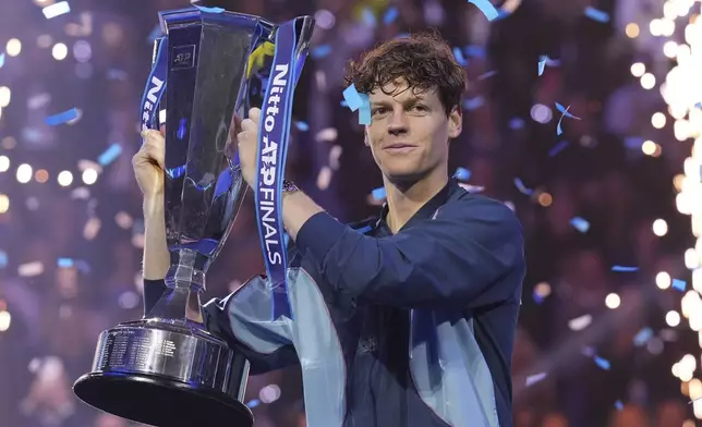 Italy's Jannik Sinner holds the trophy after winning the final match of the ATP World Tour Finals against Taylor Fritz of the United States at the Inalpi Arena, in Turin, Italy, Sunday, Nov. 17, 2024. (AP Photo/Antonio Calanni)