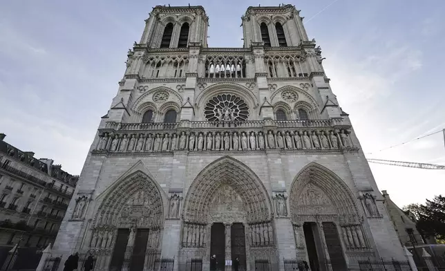 The facade of Notre-Dame Cathedral is seen in Paris, Friday Nov., 29 2024 ahead of French President Emmanuel Macron's final visit to the construction site to see the restored interiors before the iconic monument's reopening for worship on Dec. 8. (Christophe Petit Tesson, Pool via AP)