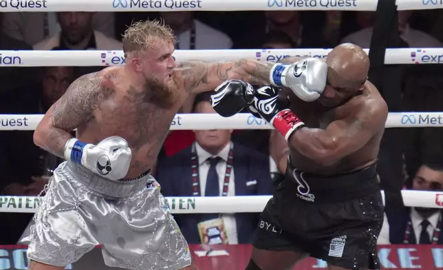 Jake Paul lands a left to Mike Tyson during their heavyweight boxing match, Friday, Nov. 15, 2024, in Arlington, Texas. (AP Photo/Julio Cortez)