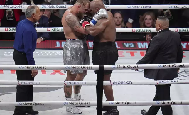 Jake Paul, left, and Mike Tyson embrace after their heavyweight boxing match, Friday, Nov. 15, 2024, in Arlington, Texas. (AP Photo/Julio Cortez)