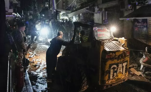 Rescue workers work at the site of an Israeli airstrike in Beirut, Lebanon, Monday, Nov. 18, 2024. (AP Photo/Bilal Hussein)