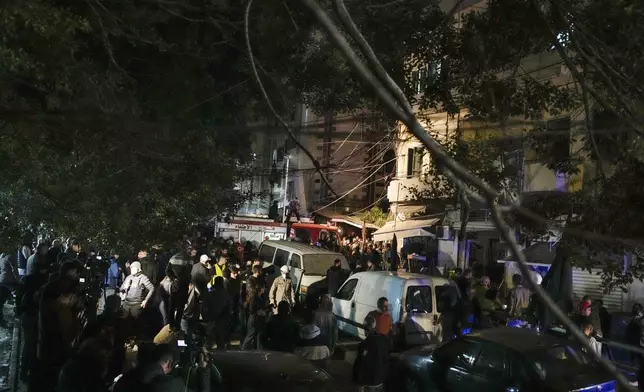 Residents and rescuers gather at the site of an Israeli airstrike in Beirut, Lebanon, Monday, Nov. 18, 2024. (AP Photo/Bilal Hussein)