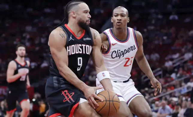 Houston Rockets forward Dillon Brooks (9) drives around Los Angeles Clippers forward Kai Jones (23) during the first half of an Emirates NBA Cup basketball game Friday, Nov. 15, 2024, in Houston. (AP Photo/Michael Wyke)